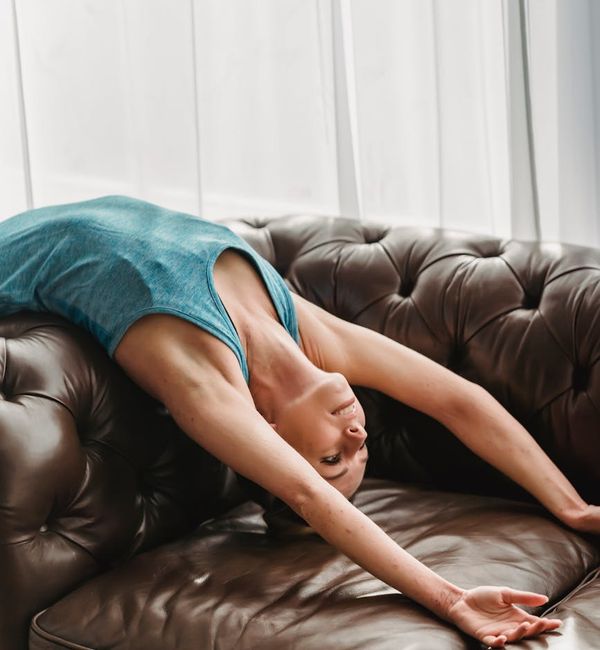 Person stretching peacefully in a bright, tranquil environment.