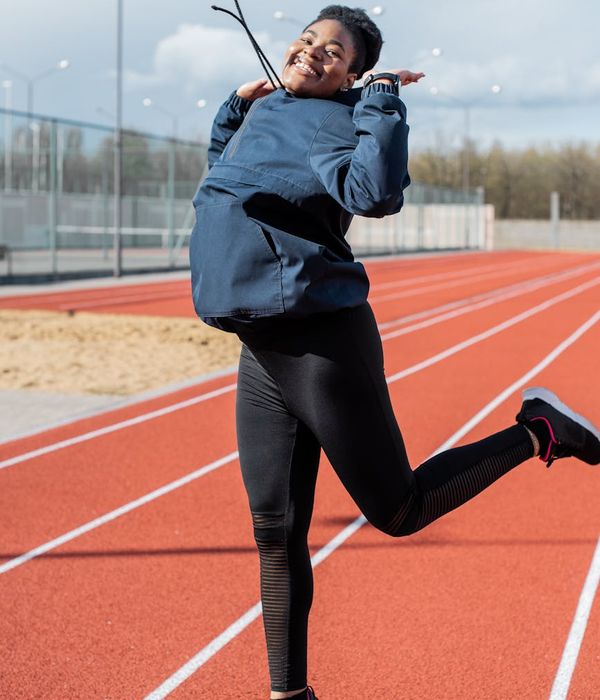 Smiling woman feeling energetic during a light cardio activity.